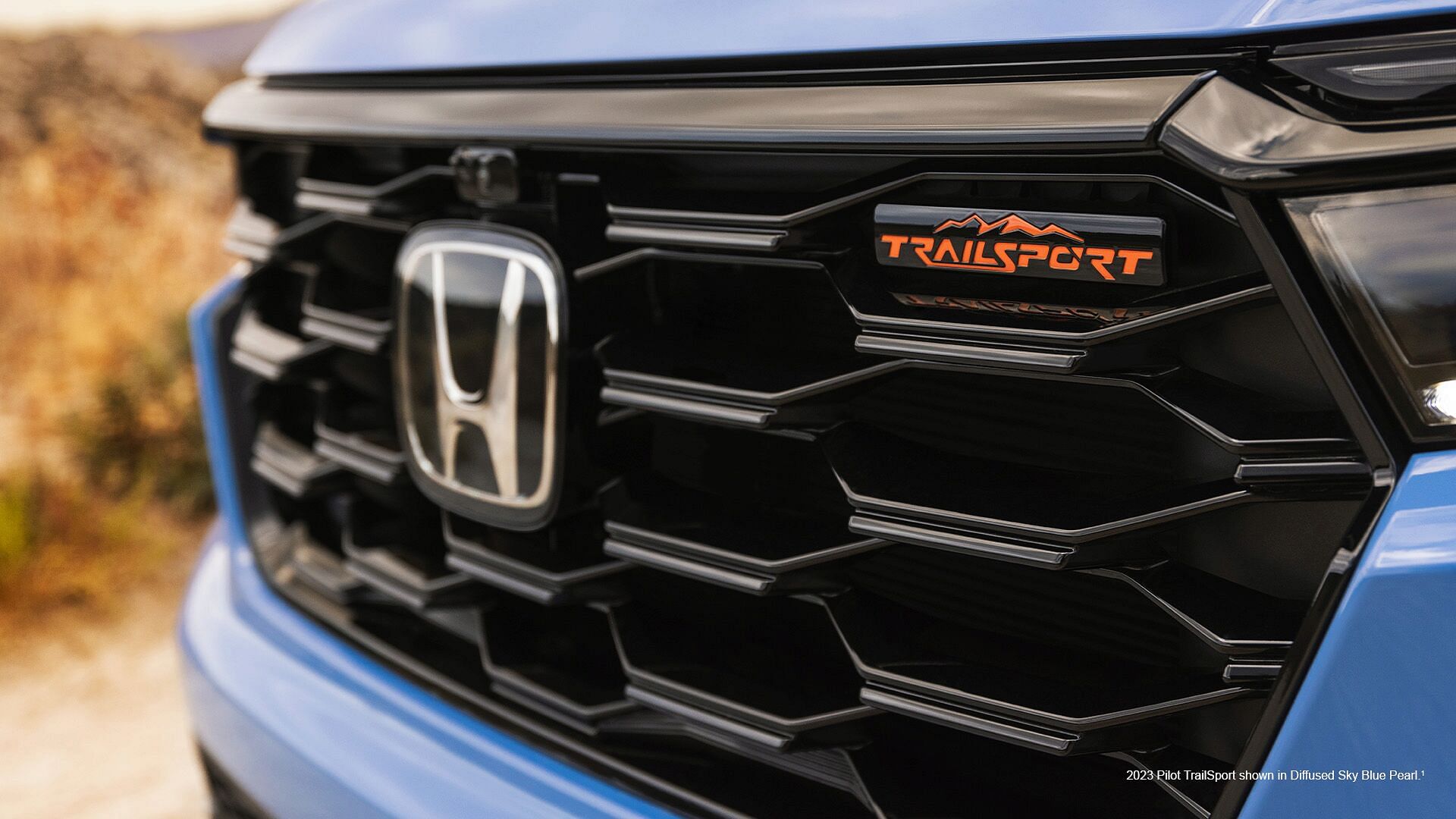 front grille of 2023 Honda Pilot TrailSport shown in Diffused Sky Blue Pearl