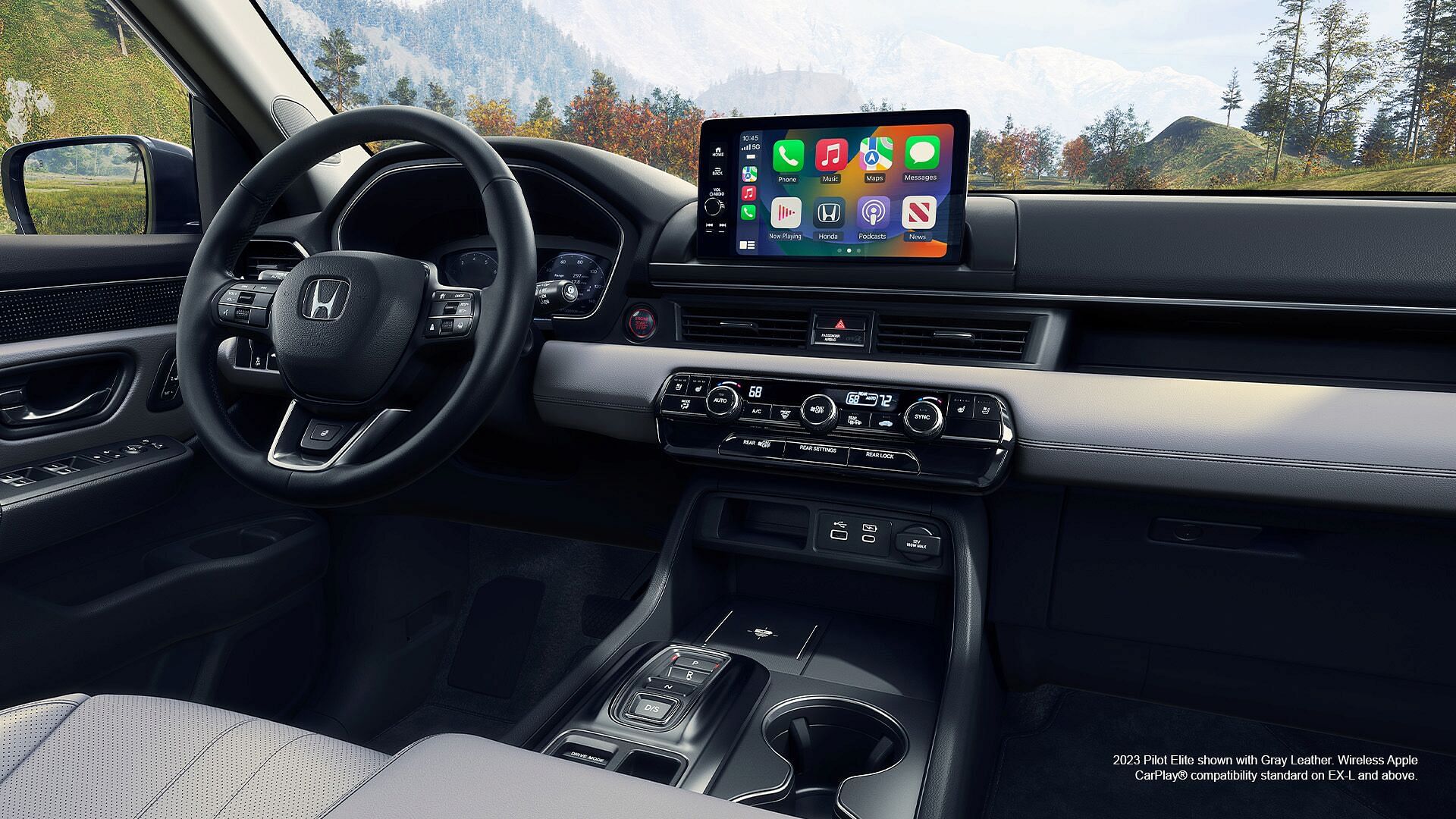 Interior of 2023 Honda Pilot Elite shown with Gray Leather. Wireless Apple CarPlay compatibility standard on EX-L and above.